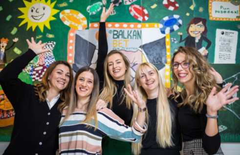 Women from the Balkan Bet team are waving happily, satisfied after the implementation of the HeartCount app