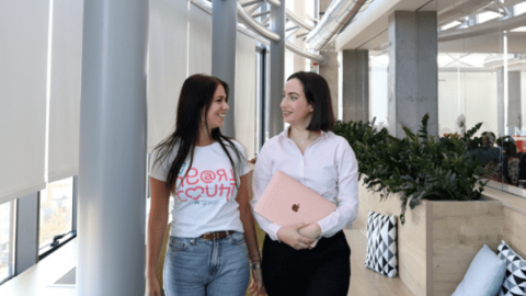 Two HeartCount employees walking and smiling