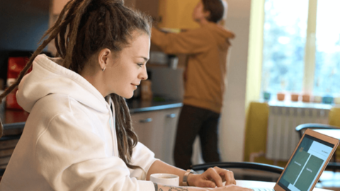 The young woman is working remotely, demonstrating how to be more productive when working from home