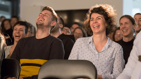 People are laughing together, showing happiness at work