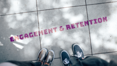 Legs with shoes and sneakers on the floor, alongside them the words "employee engagement and retention" are written