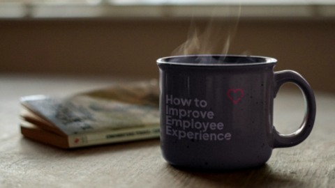 The cup of coffee with the words "How to Improve Employee Experience" written on it