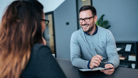 A member of the HR team doing a stay interview with a colleague