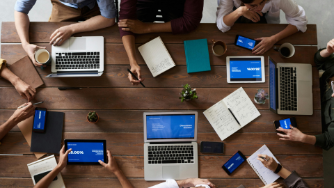 Employees with laptops in a meeting