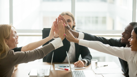 A team of employees cheering