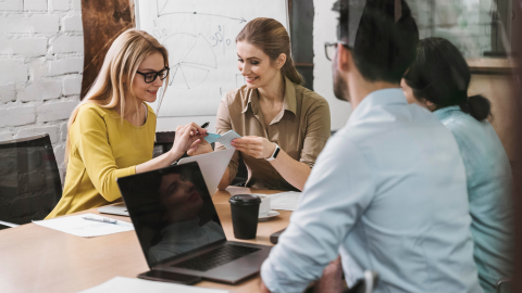 Employees discussing the difference between anonymous vs confidential survey