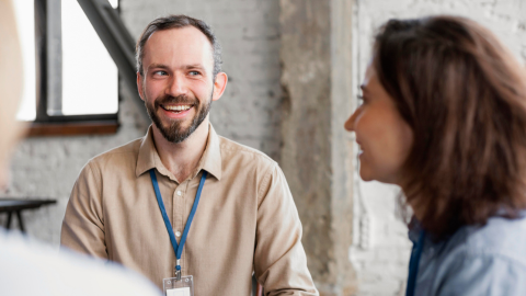 Two colleagues chatting symbolising the role of feedback