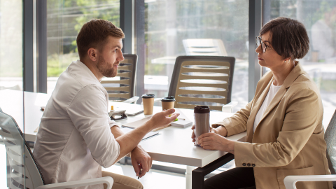 Manager talking to his employee featuring micromanagement