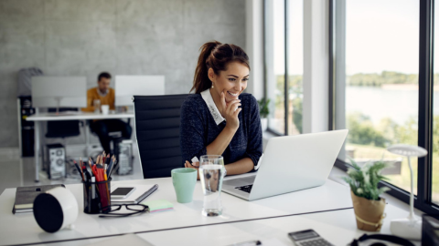 An employee working at her desk representing an exceptional employee