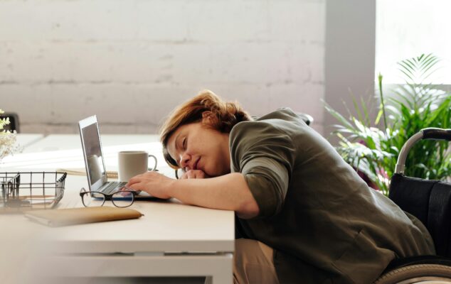 Employee showing signs of burnout at their desk, illustrating quiet quitting in the workplace.