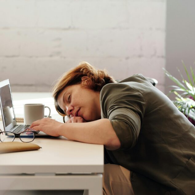 Employee showing signs of burnout at their desk, illustrating quiet quitting in the workplace.