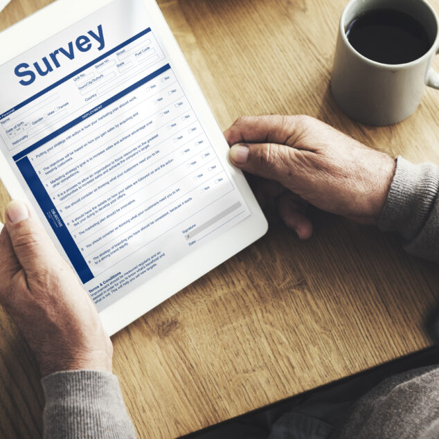 Person filling out an employee survey on a tablet using one of the best employee survey tools
