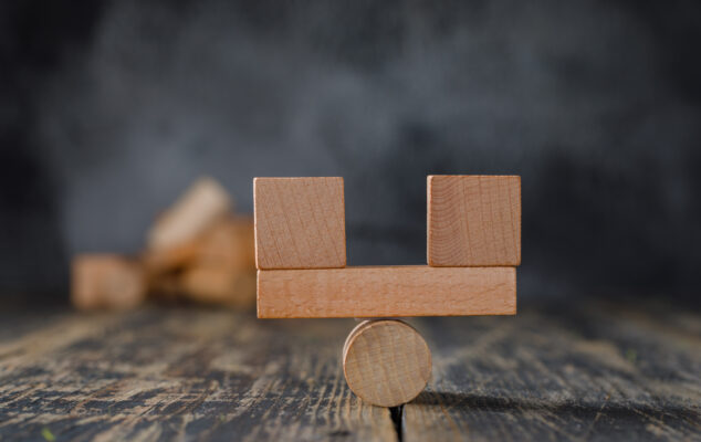 Balanced wooden blocks on a pivot symbolizing 15Five vs Workleap comparison in employee engagement software.