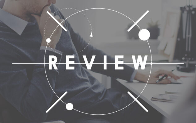 15Five review showing an HR professional evaluating performance management software at a desk