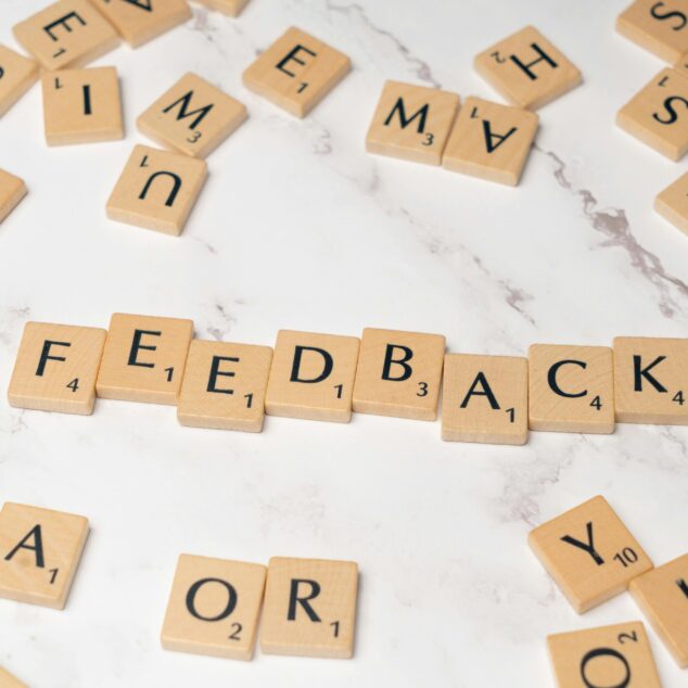 Lattice review concept showing feedback spelled with letter tiles representing performance reviews and continuous feedback